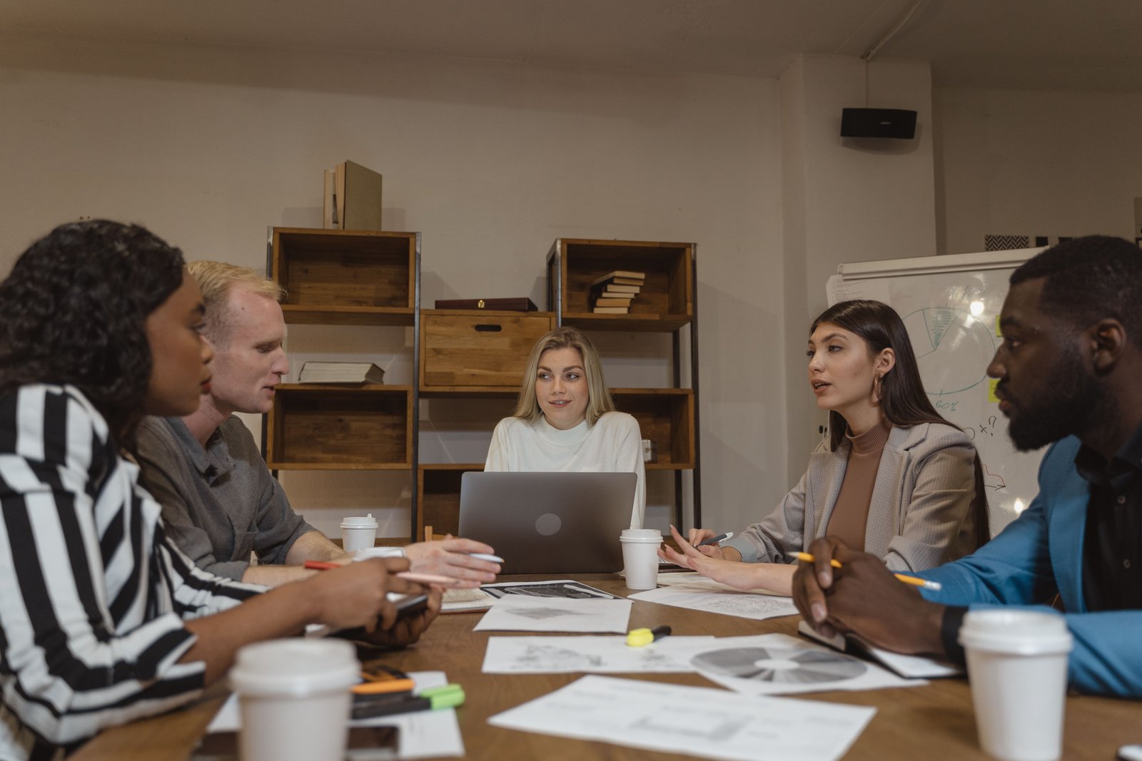 Focus group research session — diverse participants around a table with moderator